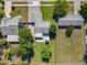 An aerial view shows a house with a patio and a gazebo, surrounded by a lawn and neighboring homes and streets at 7911 Murcott Cir, Orlando, FL 32835