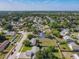 Panoramic aerial view showcasing a neighborhood with tree-lined streets and a variety of houses and well-kept lawns at 7911 Murcott Cir, Orlando, FL 32835