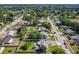 An aerial view of a residential area showcases a home with a well-maintained backyard, patio, and surrounding neighborhood at 7911 Murcott Cir, Orlando, FL 32835