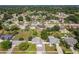 Aerial shot of a cozy neighborhood featuring a home with a well-kept lawn, gazebo, and mature trees at 7911 Murcott Cir, Orlando, FL 32835