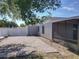 The backyard featuring a brick paved section, a screened-in patio, and a gate at 7911 Murcott Cir, Orlando, FL 32835
