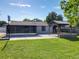 Spacious backyard with a gazebo, screened-in patio, and lush green lawn, perfect for outdoor enjoyment at 7911 Murcott Cir, Orlando, FL 32835