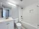 Modern bathroom featuring a white vanity, toilet, and a tub with a tiled wall at 7911 Murcott Cir, Orlando, FL 32835
