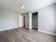 Light, airy bedroom features wood-look floors, neutral paint, and a closet with bifold doors at 7911 Murcott Cir, Orlando, FL 32835
