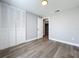 Light, airy bedroom features wood-look floors, neutral paint, and bifold closet doors at 7911 Murcott Cir, Orlando, FL 32835