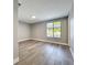 Bedroom featuring wood-look floors, a window with blinds, and neutral paint at 7911 Murcott Cir, Orlando, FL 32835