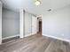 Light, airy bedroom features wood-look floors, neutral paint, and a closet with folding door at 7911 Murcott Cir, Orlando, FL 32835