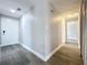 Hallway featuring wood flooring, with white door and trim at 7911 Murcott Cir, Orlando, FL 32835