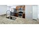Kitchen showcasing granite countertops, stainless steel appliances, wooden cabinets, and a modern faucet at 7911 Murcott Cir, Orlando, FL 32835
