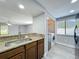 View of the kitchen, showcasing the stainless steel sink, and laundry area with washer and dryer at 7911 Murcott Cir, Orlando, FL 32835