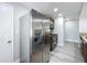 Spacious kitchen featuring stainless steel appliances, wooden cabinets, and stylish, light-colored wood flooring at 7911 Murcott Cir, Orlando, FL 32835