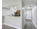 View of kitchen with granite countertops, stainless appliances and wood cabinetry from the entryway at 7911 Murcott Cir, Orlando, FL 32835