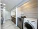 Bright laundry area with modern washer and dryer, plus wire shelving for convenient storage solutions at 7911 Murcott Cir, Orlando, FL 32835