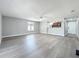 Large living room featuring light wood floors, ceiling fan, and a view of kitchen and entryway at 7911 Murcott Cir, Orlando, FL 32835