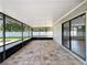 Wide view of the screened-in lanai with brick pavers, leading to an outdoor space at 7911 Murcott Cir, Orlando, FL 32835
