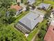 Aerial shot of a residential property showcasing the roof, large screened patio, and mature landscaping at 8080 Peaceful Cir, Sanford, FL 32771