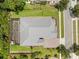 Overhead of home featuring an enclosed patio, manicured lawn, and landscaped yard at 8080 Peaceful Cir, Sanford, FL 32771