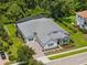 Stunning aerial view of a single-story home with a screened-in pool, lush landscaping, and mature trees at 8080 Peaceful Cir, Sanford, FL 32771