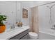 Bathroom featuring a combination tub and shower, quartz vanity, decorative mirror, and grey cabinets at 8080 Peaceful Cir, Sanford, FL 32771