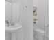 Well-lit bathroom with a sink, toilet, and artistic decor at 8080 Peaceful Cir, Sanford, FL 32771