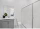 Bathroom features a modern vanity with gray cabinetry, sleek fixtures, toilet and an enclosed glass shower at 8080 Peaceful Cir, Sanford, FL 32771