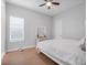 Bright bedroom with a ceiling fan, white furniture, and neutral decor at 8080 Peaceful Cir, Sanford, FL 32771