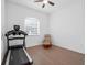 Bright bedroom featuring a ceiling fan, chair and hardwood flooring at 8080 Peaceful Cir, Sanford, FL 32771
