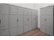 Spacious closet featuring multiple storage cabinets with dark hardware and wood flooring at 8080 Peaceful Cir, Sanford, FL 32771
