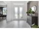 Bright entryway showcasing white tile flooring, frosted double doors and neutral walls at 8080 Peaceful Cir, Sanford, FL 32771