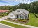 Elegant single-story home featuring stone accents, a well-manicured lawn, and mature trees at 8080 Peaceful Cir, Sanford, FL 32771