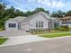 Lovely single-story home featuring an attached garage, landscaped yard, and stone detailing at 8080 Peaceful Cir, Sanford, FL 32771