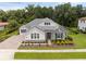 Beautiful single-story home featuring blue shutters and stone accents, surrounded by lush landscaping at 8080 Peaceful Cir, Sanford, FL 32771