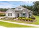 Charming single-story home with well-maintained landscaping, stone details and blue shutters at 8080 Peaceful Cir, Sanford, FL 32771