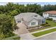Charming home with a gray roof, stone accents, blue shutters, and a well-manicured front yard at 8080 Peaceful Cir, Sanford, FL 32771