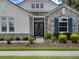 Elegant home exterior featuring a stone facade, well-kept landscaping, and striking blue shutters at 8080 Peaceful Cir, Sanford, FL 32771