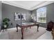Stylish home office with a decorative table, a patterned rug, and modern artwork at 8080 Peaceful Cir, Sanford, FL 32771