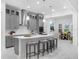 Modern kitchen featuring a large island with seating, stainless steel appliances, and gray cabinetry at 8080 Peaceful Cir, Sanford, FL 32771