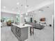 Open-concept kitchen featuring an island with a sink, stainless steel appliances, and views into the living room at 8080 Peaceful Cir, Sanford, FL 32771