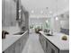 Spacious, modern kitchen featuring stainless steel appliances, sleek gray cabinetry, and a large center island at 8080 Peaceful Cir, Sanford, FL 32771