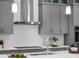 Modern kitchen details featuring a stainless steel range hood, gray cabinets, and sleek countertops at 8080 Peaceful Cir, Sanford, FL 32771