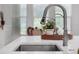 Close-up of the kitchen sink and faucet, with a view of the breakfast nook and white cabinets at 8080 Peaceful Cir, Sanford, FL 32771