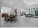 Bright, open-concept living and dining area with tile flooring, tray ceilings, and seamless flow into kitchen at 8080 Peaceful Cir, Sanford, FL 32771