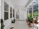 Spacious living area with tiled floors, built-in storage, and access to a bathroom and outdoor patio at 8080 Peaceful Cir, Sanford, FL 32771