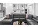 Bright, open-concept living room features a large sectional sofa and view to kitchen at 8080 Peaceful Cir, Sanford, FL 32771