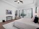 Comfortable main bedroom featuring a king-sized bed, sitting area, and large windows for ample natural light at 8080 Peaceful Cir, Sanford, FL 32771