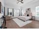 Elegant main bedroom with a large bed, sitting area, and ample natural light at 8080 Peaceful Cir, Sanford, FL 32771
