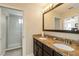 Bathroom featuring double sinks, granite countertops, and a glass enclosed shower at 8219 Roseville Blvd, Davenport, FL 33896