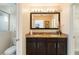 Bathroom featuring double sinks, granite countertops, and a large mirror at 8219 Roseville Blvd, Davenport, FL 33896