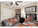 Bedroom featuring two twin beds, ceiling fan, and closet at 8219 Roseville Blvd, Davenport, FL 33896