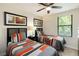 Comfortable bedroom with two twin beds, ceiling fan, and natural light at 8219 Roseville Blvd, Davenport, FL 33896